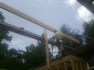 Carpenter setting a ridge beam over a new addition frame — Ice Dam Removal by Roofing Brothers in Mount Pleasant Mills