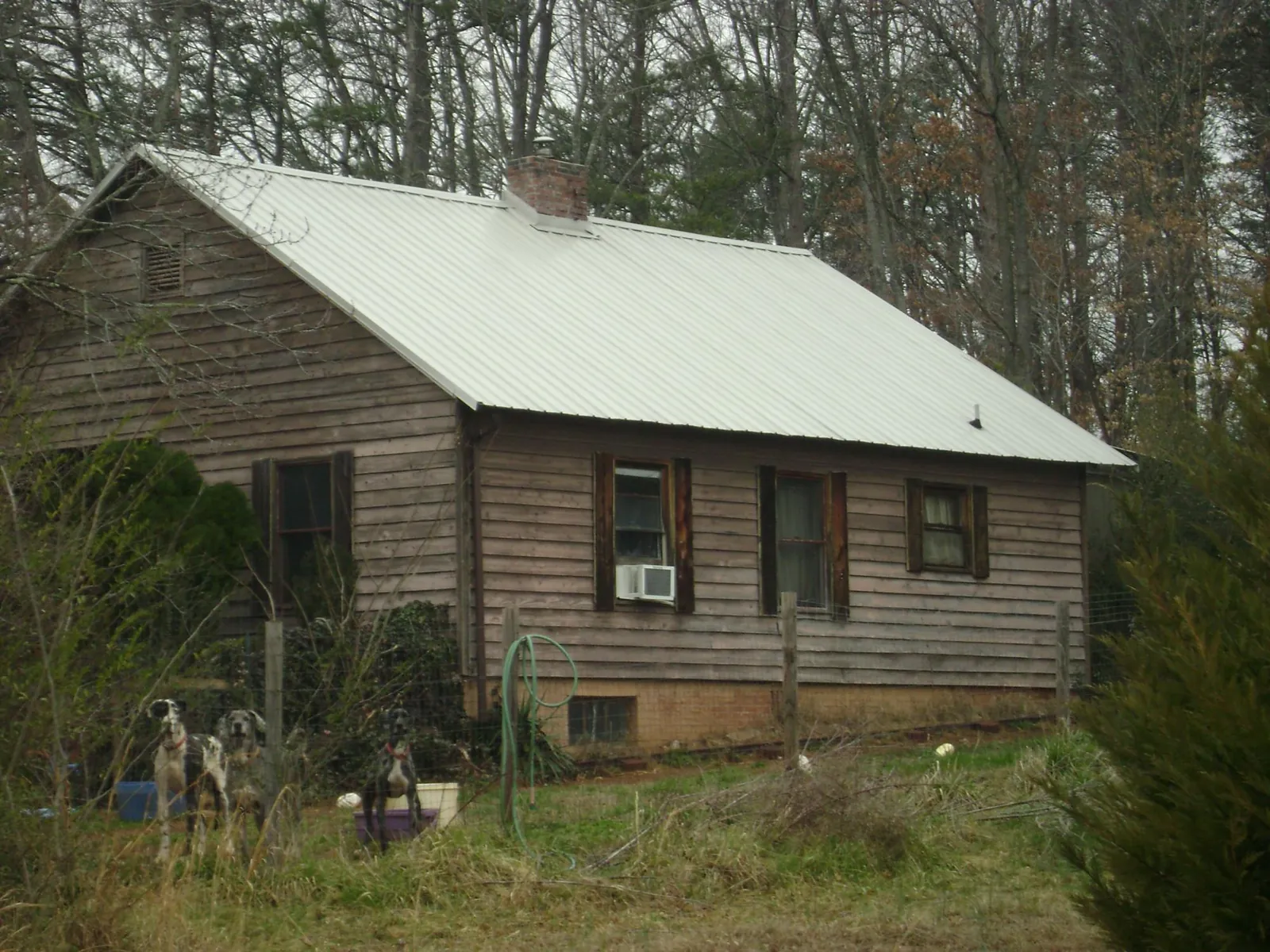 White metal roof on an old wood sided farmhouse, from a Metal Roof Installation job in Mount Pleasant Mills